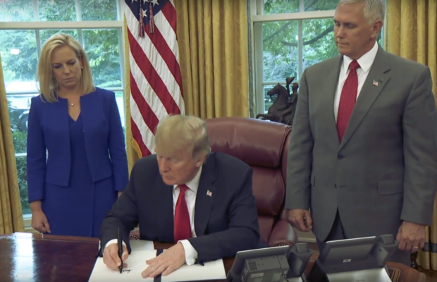 Donald Trump and Mike Pence and Kirstjen Nielsen at signing of executive order on family separation