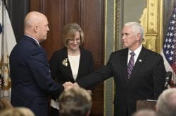 Vice President Mike Pence shakes another person's hand.