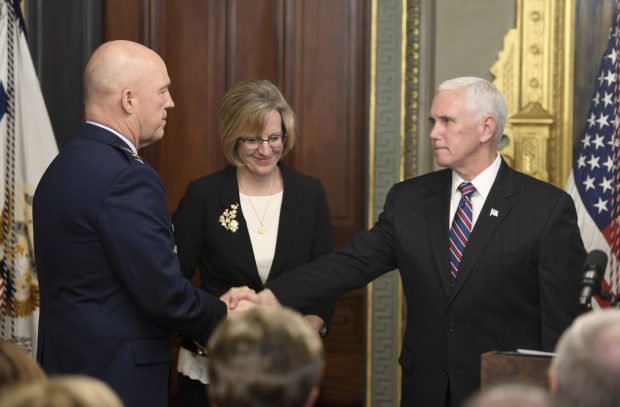 Vice President Mike Pence shakes another person's hand.