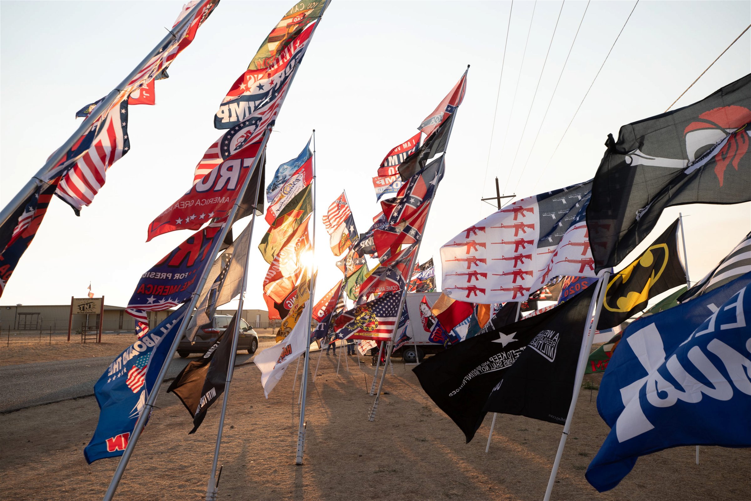 Flags fly outside Cooks Garage, the meeting place of hundreds of President Donald Trump supporters after a "Trump Train" car parade in Lubbock, Texas, on Sunday, Oct. 18, 2020. (Kaylee Greenlee - DCNF)