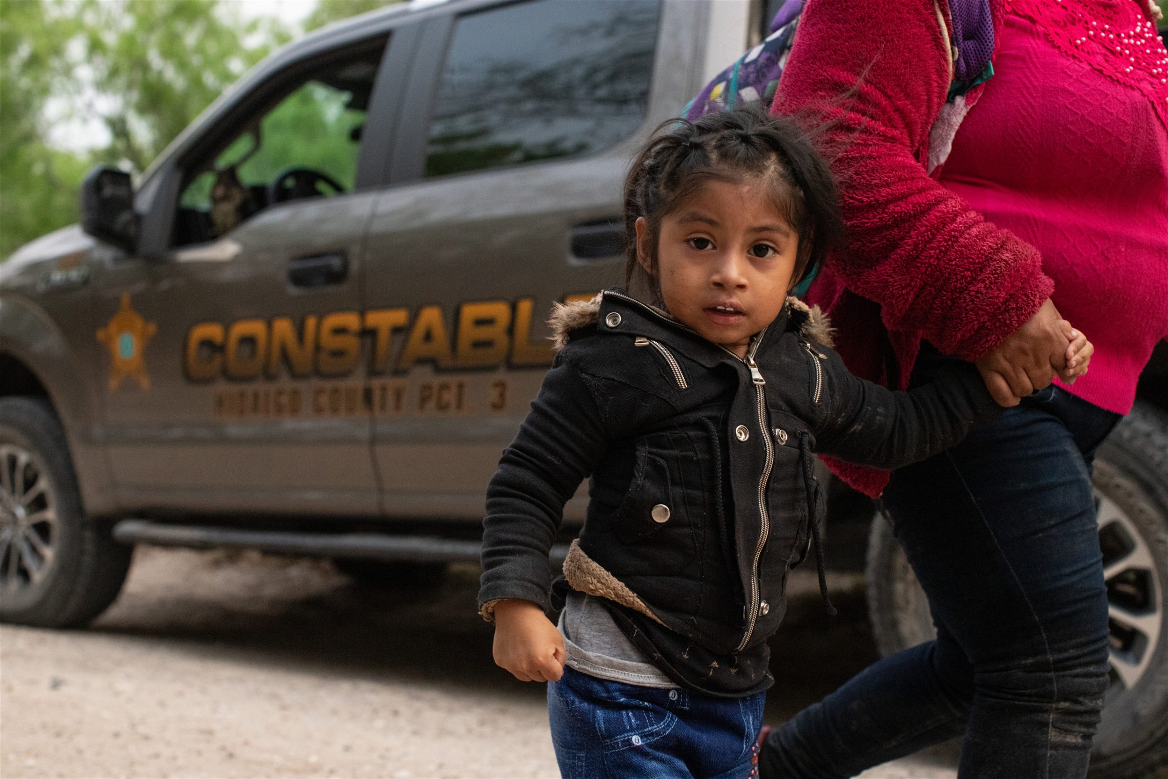 Illegal migrants make their way to a processing facility after they were smuggled into the U.S. and officials with the Hidalgo County Constable's office gathered biometrical data from them before releasing them in Rincon Village near McAllen, Texas, on March 24, 2021. (Kaylee Greenlee. - Daily Caller News Foundation)
