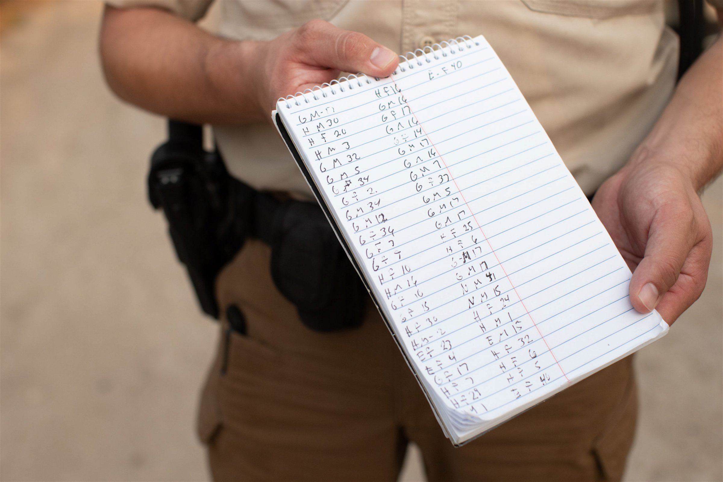An official with the Hidalgo County Constable's office shows a notepad used to gather biometric data from illegal immigrants shortly after they were smuggled into the U.S. in Rincon Village near McAllen, Texas, on March 24, 2021. (Kaylee Greenlee. - Daily Caller News Foundation)