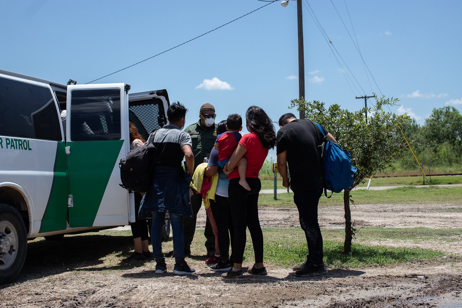 Migrants make their way to a Border Patrol transport vehicle after illegally entering the U.S. near ​La Joya, Texas, on August 7, 2021. (Kaylee Greenlee - Daily Caller News Foundation)