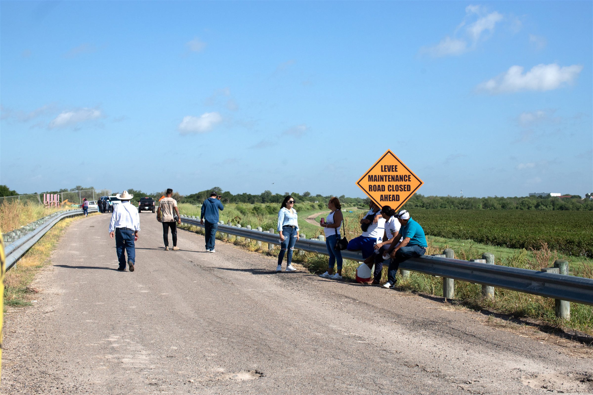 Around two dozen people waited at the endge of Anzalduas Park to pick up friends and family members who tested positive for COVID-19 after entering the U.S. illegally in Mission, Texas, on August 8, 2021. (Kaylee Greenlee - Daily Caller News Foundation)