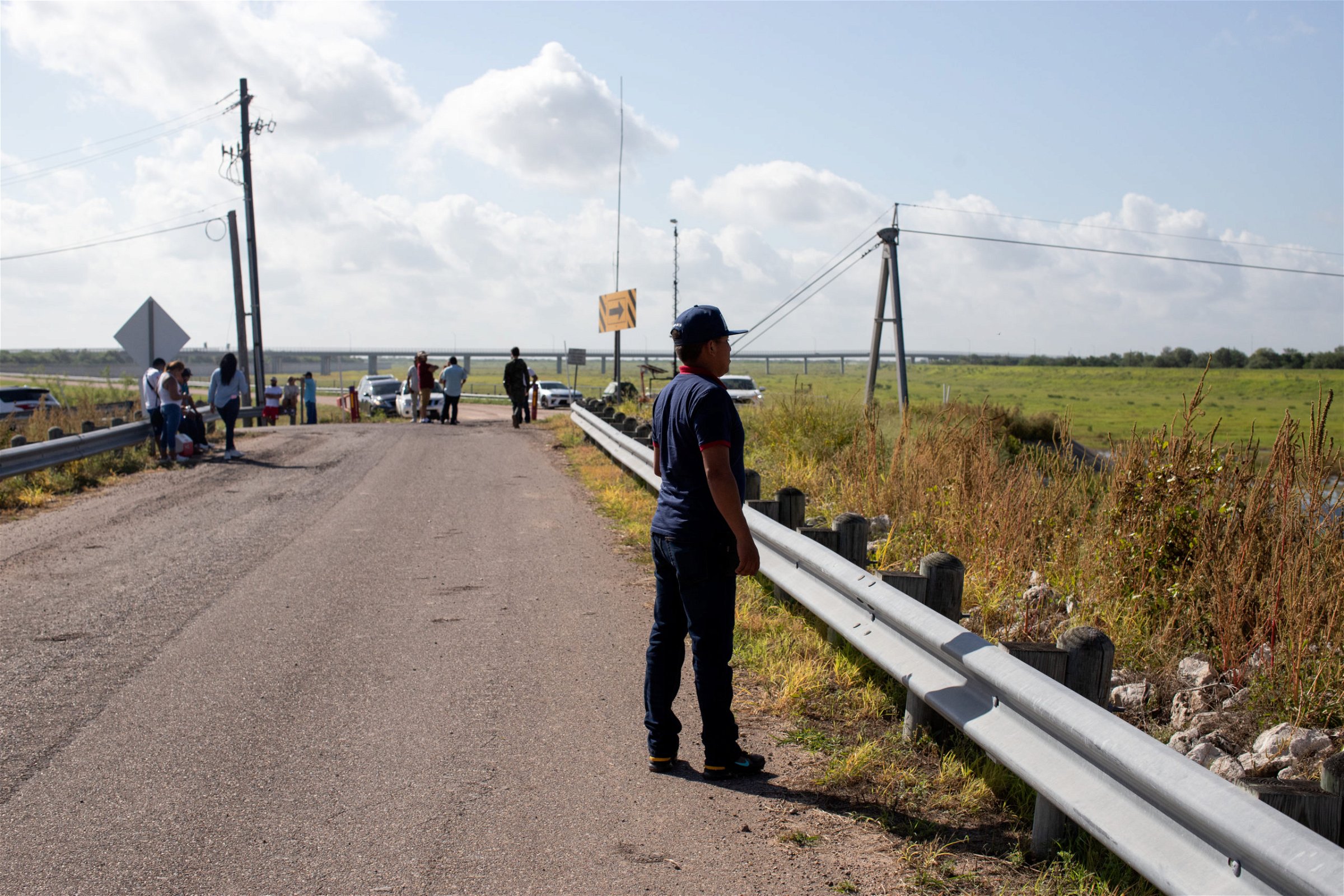 Around two dozen people waited at the endge of Anzalduas Park to pick up friends and family members who tested positive for COVID-19 after entering the U.S. illegally in Mission, Texas, on August 8, 2021. (Kaylee Greenlee - Daily Caller News Foundation)