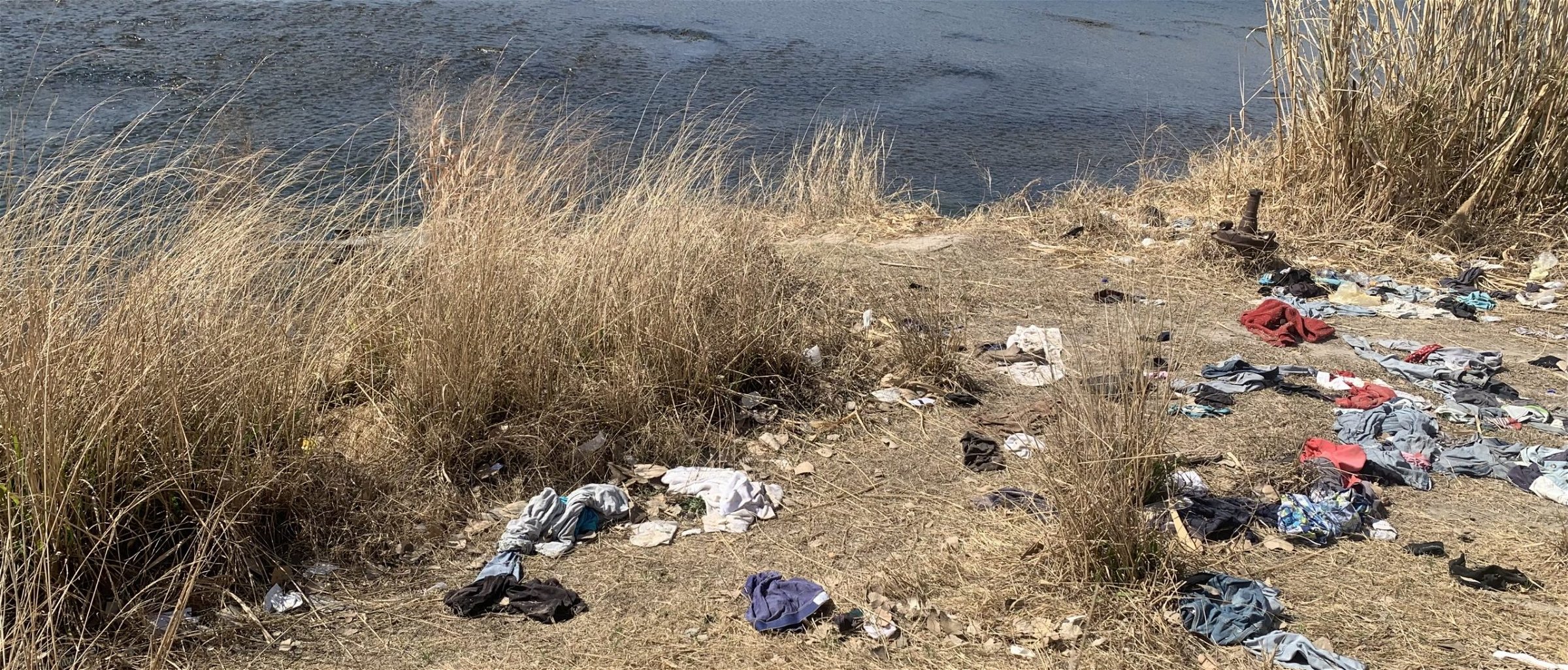 Wet clothes sit along the river where migrants have crossed from Mexico into Del Rio, Texas (Jennie Taer//Daily caller News Foundation)